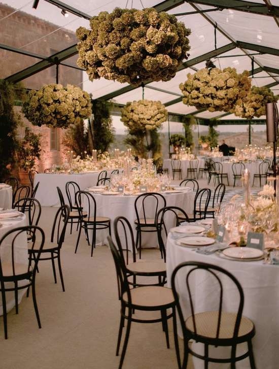 Inspiration image: an evening dinner under a tent canopy with hydrangea chandeliers