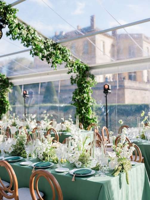 Inspiration image: a long table set in green and white under a tent canopy
