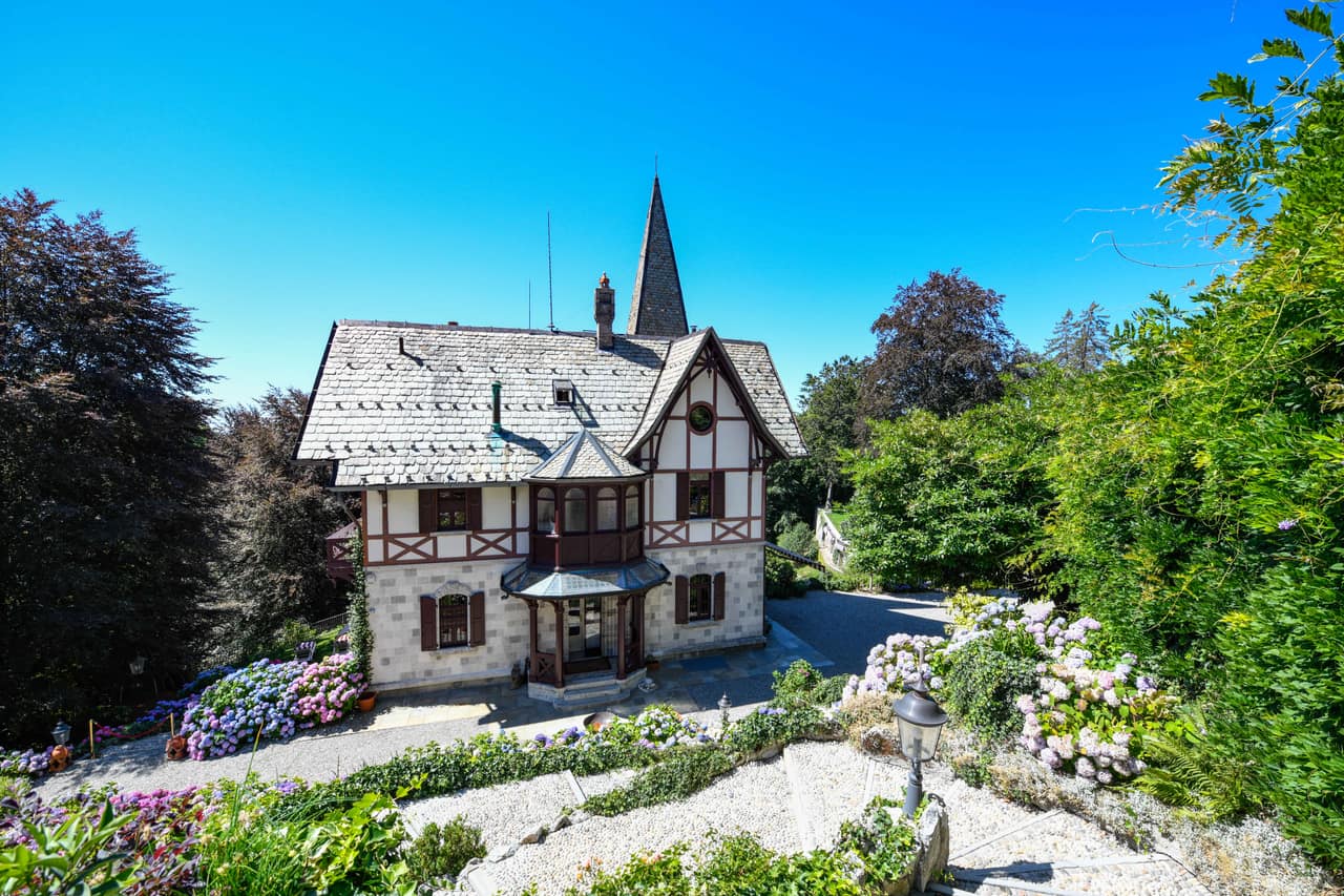 The 1892 facade of Villino Rubini in Brunate, its spire above the gravel drive and the hydrangea beds
